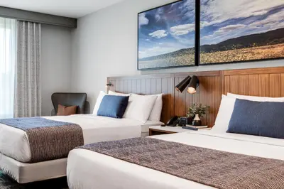 a hotel room with two beds and a tv at Ayres Hotel Vista Carlsbad in Vista