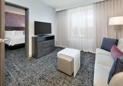 a hotel room with a couch and a tv and a bed at Homewood Suites By Hilton Irvine Spectrum Lake Forest in Lake Forest
