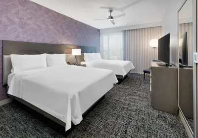 a hotel room with two beds and a flat screen tv at Homewood Suites By Hilton Irvine Spectrum Lake Forest in Lake Forest