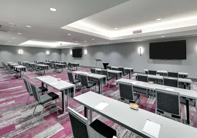a classroom with tables and chairs and a projection screen at Homewood Suites By Hilton Irvine Spectrum Lake Forest in Lake Forest