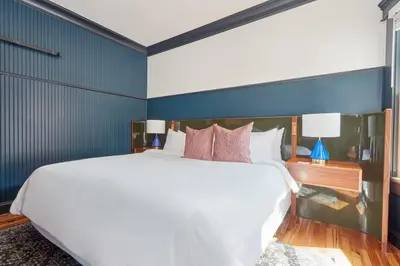 a bedroom with a large white bed and blue walls at The Davis Downtown San Diego in San Diego