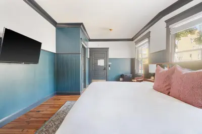 a bedroom with a large bed with a flat screen tv at The Davis Downtown San Diego in San Diego