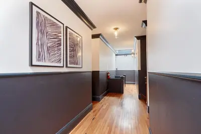 a hallway with a long corridor with paintings on the wall at The Davis Downtown San Diego in San Diego