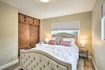a bedroom with a large bed and a window at Coastal Carlsbad Home 1 Mi to Beach and Downtown in Carlsbad