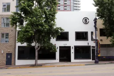 a white building with a tree in front of it at Stay Classy in San Diego