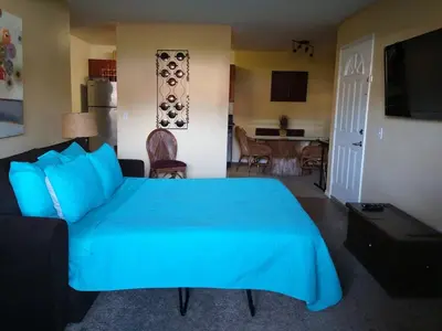a bedroom with a blue bed and a living room at Departamento completo en San Diego & Bonita You can ask for 30 or more days book and save aditional 15 percent in San Diego