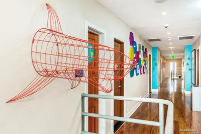 a wire basket on the wall of a hallway at Samesun Ocean Beach Hotel & Hostel in San Diego