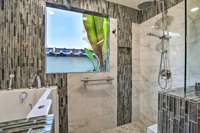 a bathroom with a shower with a glass door at Luxe El Cajon Oasis with Pool, Fire Pit and Pavilion in El Cajon