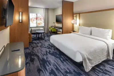 a hotel room with a large bed and a desk at Fairfield Inn & Suites by Marriott Menifee in Menifee