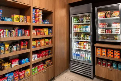 a grocery store aisle with two refrigerators at Fairfield Inn & Suites by Marriott Menifee in Menifee
