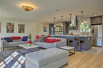 a living room with a couch and a kitchen at Oceanside Home with Patio and Grill, Walk to Beach! in Oceanside