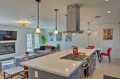 a kitchen and living room with a stove top oven at Oceanside Home with Patio and Grill, Walk to Beach! in Oceanside