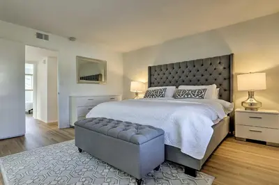 a bedroom with a large bed with a large headboard at Oceanside Home with Patio and Grill, Walk to Beach! in Oceanside
