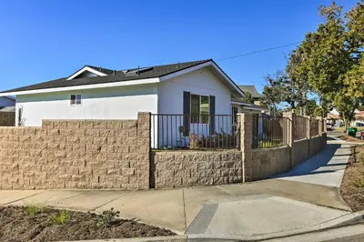 a house with a retaining wall and a fence at Oceanside Home with Patio and Grill, Walk to Beach! in Oceanside