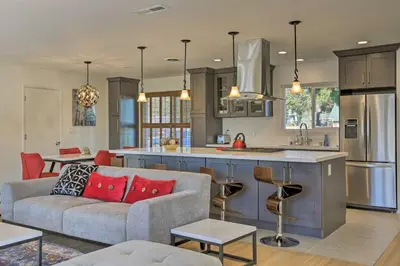 a kitchen and living room with a couch and a table at Oceanside Home with Patio and Grill, Walk to Beach! in Oceanside