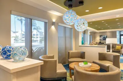 a lobby with a table and chairs and a dining room at SpringHill Suites by Marriott San Diego Carlsbad in Carlsbad