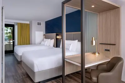 a hotel room with two beds and a desk at SpringHill Suites by Marriott San Diego Carlsbad in Carlsbad