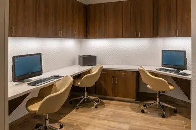 a room with two desks with two computers and chairs at SpringHill Suites by Marriott San Diego Carlsbad in Carlsbad