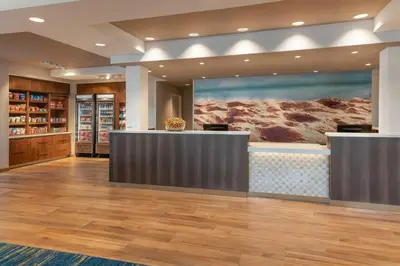 a lobby with a reception desk and a painting at SpringHill Suites by Marriott San Diego Carlsbad in Carlsbad