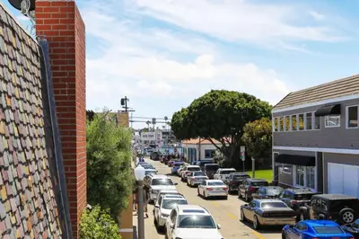 a city street with cars parked in a parking lot at 128 Agate in Newport Beach
