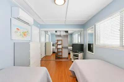 a bedroom with two beds and a television in it at 128 Agate in Newport Beach