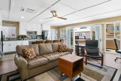 a living room with a couch and a kitchen at 128 Agate in Newport Beach