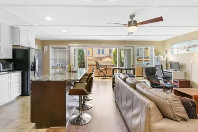 a kitchen and living room with a couch and a bar at 128 Agate in Newport Beach