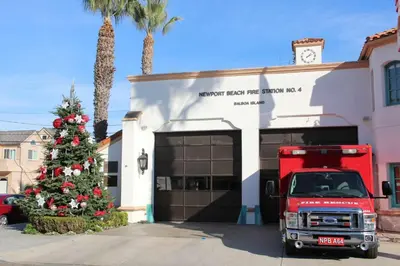 a fire truck parked in front of a building with a christmas tree at 1106 Park Avenue in Newport Beach