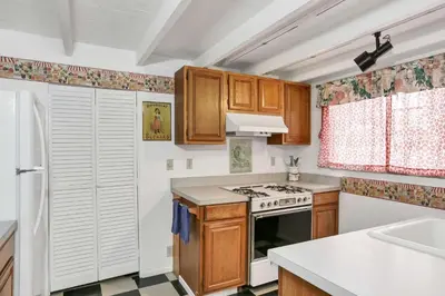 a kitchen with wooden cabinets and a stove top oven at 1106 Park Avenue in Newport Beach