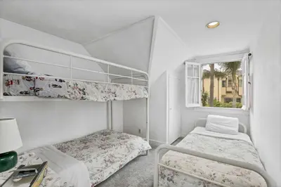 a bedroom with two bunk beds and a window at 201 Amethyst Avenue in Newport Beach