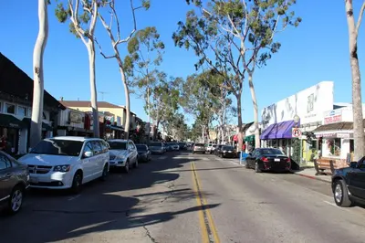 a street with cars parked on the side of the road at 201 Amethyst Avenue in Newport Beach