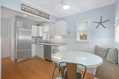 a kitchen and living room with a table and a refrigerator at 307 Thirty Fifth Street in Newport Beach