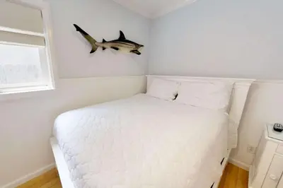 a bedroom with a bed with a shark head on the wall at 307 Thirty Fifth Street in Newport Beach