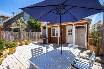 a blue umbrella sitting on top of a wooden deck at 307 Thirty Fifth Street in Newport Beach