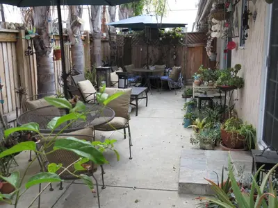 an outdoor patio with tables and chairs and plants at Always Inn San Clemente Bed & Breakfast by Elevate Rooms in San Clemente