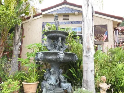 a statue of children around a fountain in a garden at Always Inn San Clemente Bed & Breakfast by Elevate Rooms in San Clemente