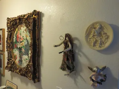 a mirror and some figurines on a wall at Always Inn San Clemente Bed & Breakfast by Elevate Rooms in San Clemente