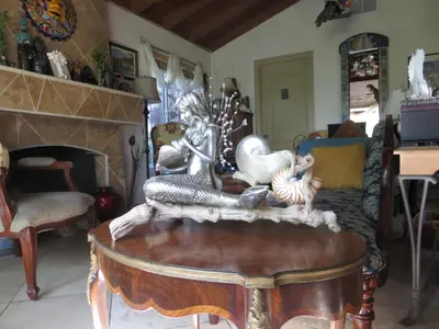 a living room with a table with figurines on it at Always Inn San Clemente Bed & Breakfast by Elevate Rooms in San Clemente