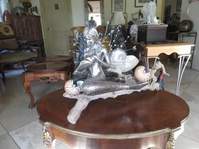 a statue of a man riding a fish on a table at Always Inn San Clemente Bed & Breakfast by Elevate Rooms in San Clemente