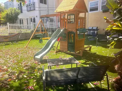 a playground with a slide and a play house at Casita San Diego in San Diego
