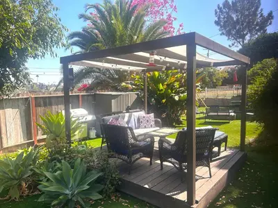 a pergola with a table and chairs on a deck at Casita San Diego in San Diego