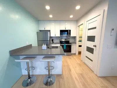 a kitchen with a island with two bar stools at Casita San Diego in San Diego