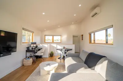 a living room with a couch and a desk at Fern House South Park Craftsman in San Diego