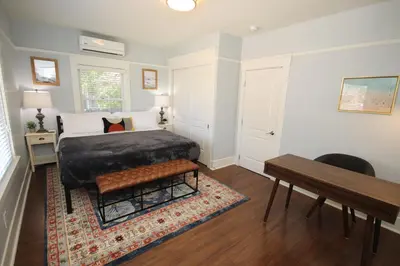 a bedroom with a bed and a table and a desk at Fern House South Park Craftsman in San Diego