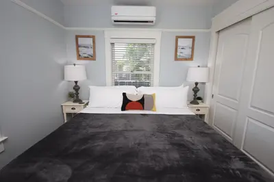 a bedroom with a large bed with two lamps at Fern House South Park Craftsman in San Diego