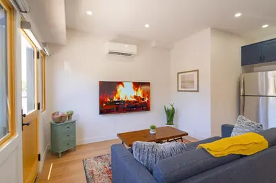 a living room with a blue couch and a table at Fern House South Park Craftsman in San Diego