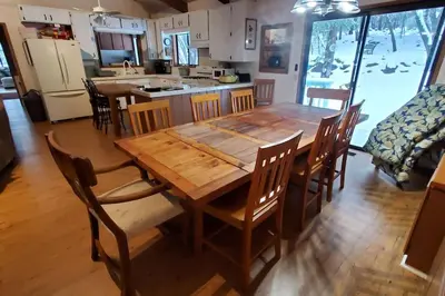 a wooden dining room table and chairs in a kitchen at Pine Hills Cabin in Julian in Julian