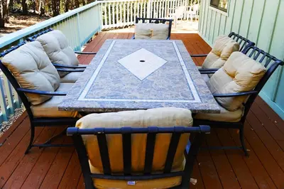 a table and four chairs on a porch with a table at Pine Hills Cabin in Julian in Julian