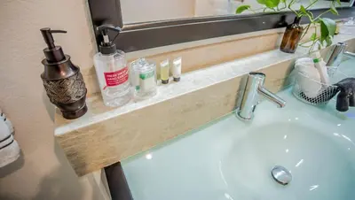 a bathroom sink with a wooden shelf above it at Buena Creek Vista Primary Subdivided Home with Views and Pool in San Marcos
