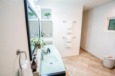 a bathroom with a sink and a mirror at Buena Creek Vista Primary Subdivided Home with Views and Pool in San Marcos